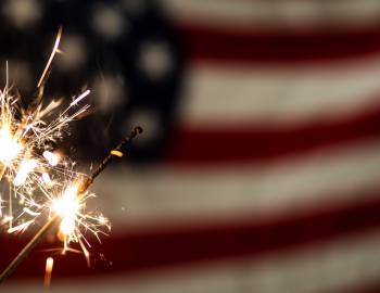 Sparkler in front of a flag