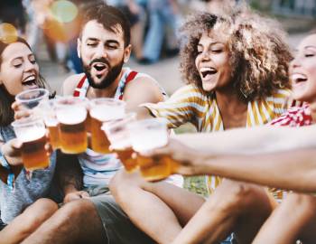 Group Of Friend Enjoying Beers Outdoors At A Festival