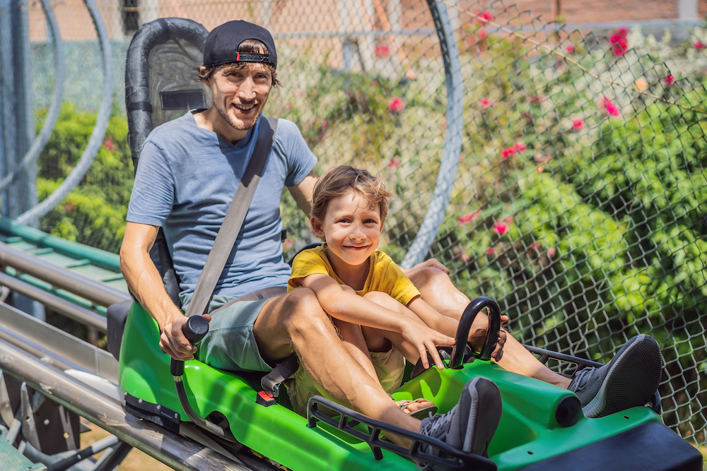 Man and child on an alpine coaster