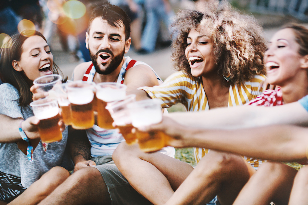 Group Of Friend Enjoying Beers Outdoors At A Festival