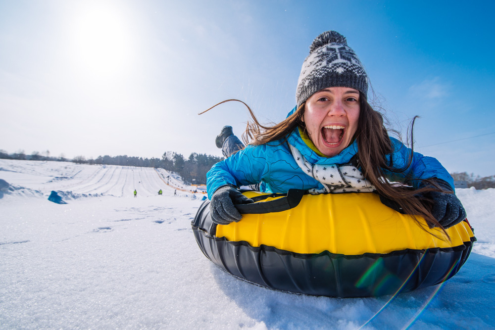 Woman Riding a Snow Tube at Frisco Adventure Park Near Copper Mountain